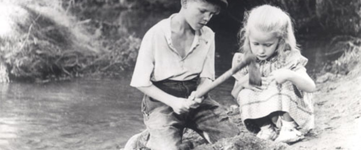 Michel helps Brigitte dig a grave for her dead puppy in the 1952 film Forbidden Games