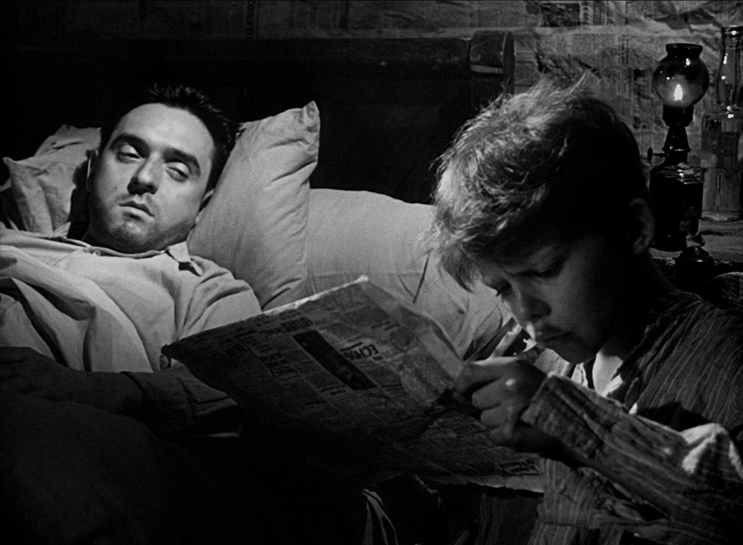 Michel reads to his dying brother in a scene from the 1952 film Forbidden Games