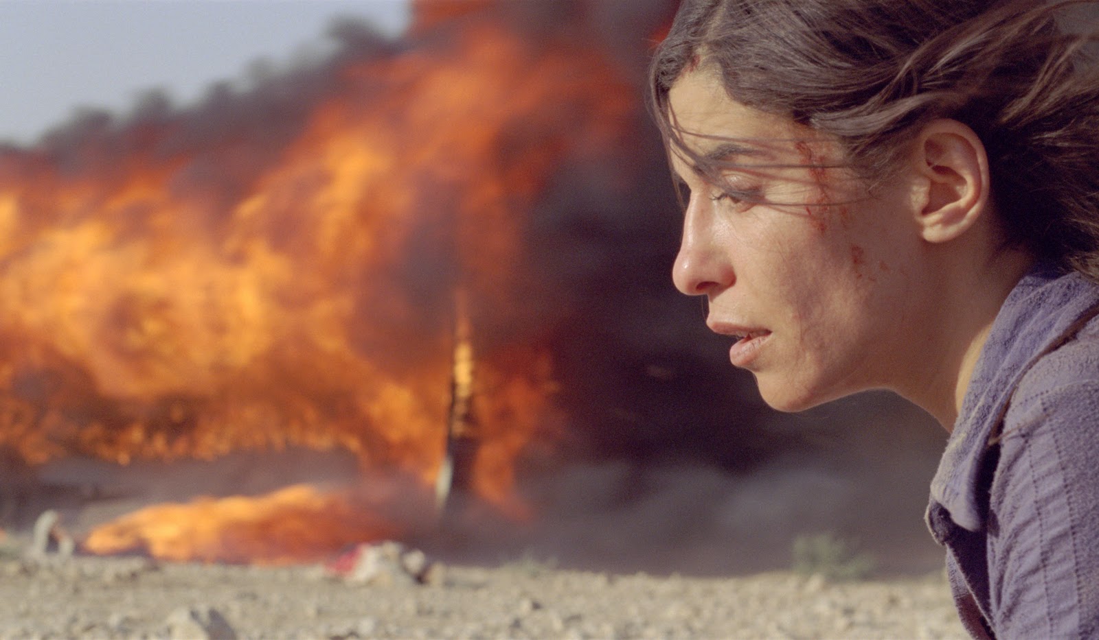 Still from the 2010 Denis Villeneuve film Incendies in which Nawal (Lubna Azabal) has just survived the execution of everyone on a bus she been in.