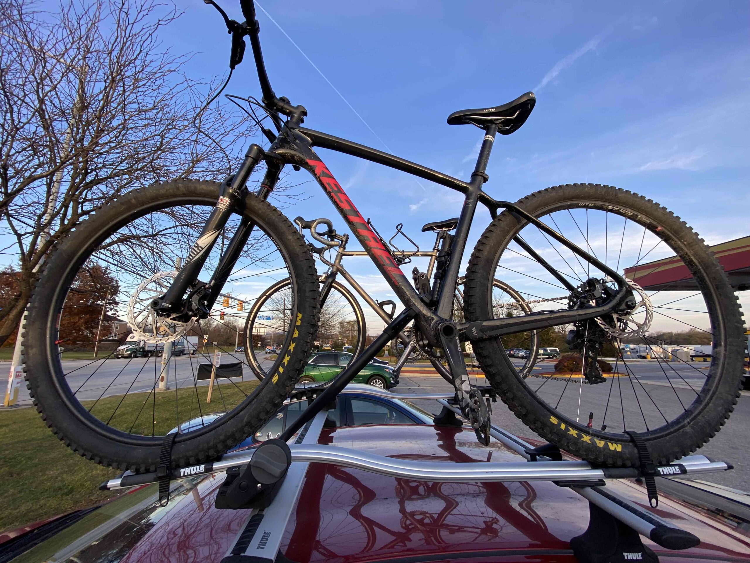 Picture of the 2017 Kestrel MXZ mountain bike on a roof car rack alongside a 2003 LeMond Arrivée road bike with HED rims