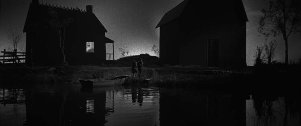 A scene from "Night of the Hunter" with the shadows of two houses on the horizon.