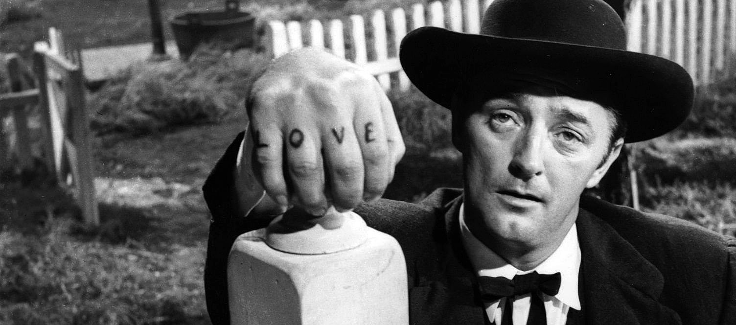 Robert Mitchum as the minister with the fist tattooed with "LOVE"