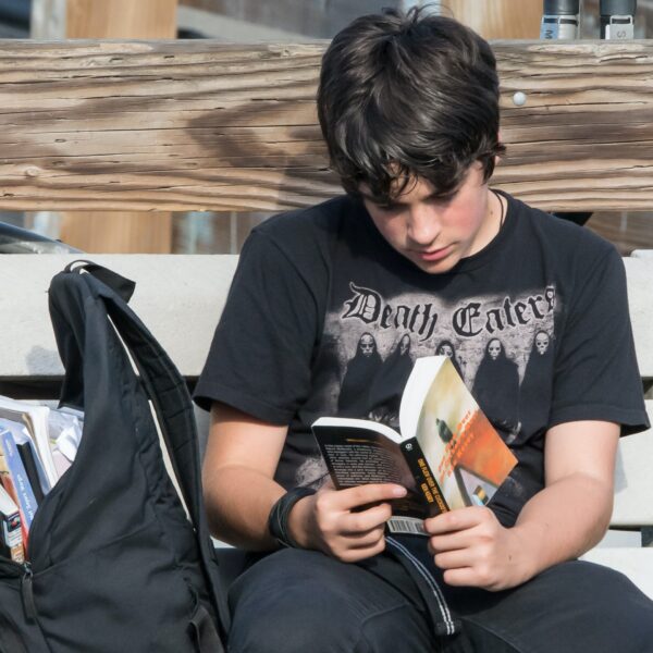 A boy reading a book. Photo by Islander Images on Unsplash