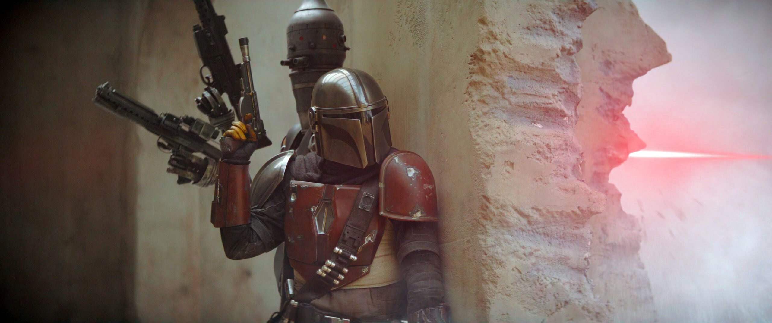 Image from "The Mandalorian" in which IG11 and the title character are involved in a shootout