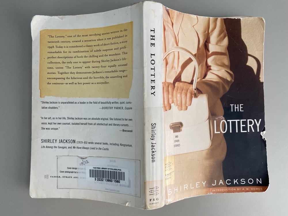 A weathered copy of Shirley Jackson's "The Lottery and Other Stories" from Free Library of Philadelphia, which includes "Flower Garden"