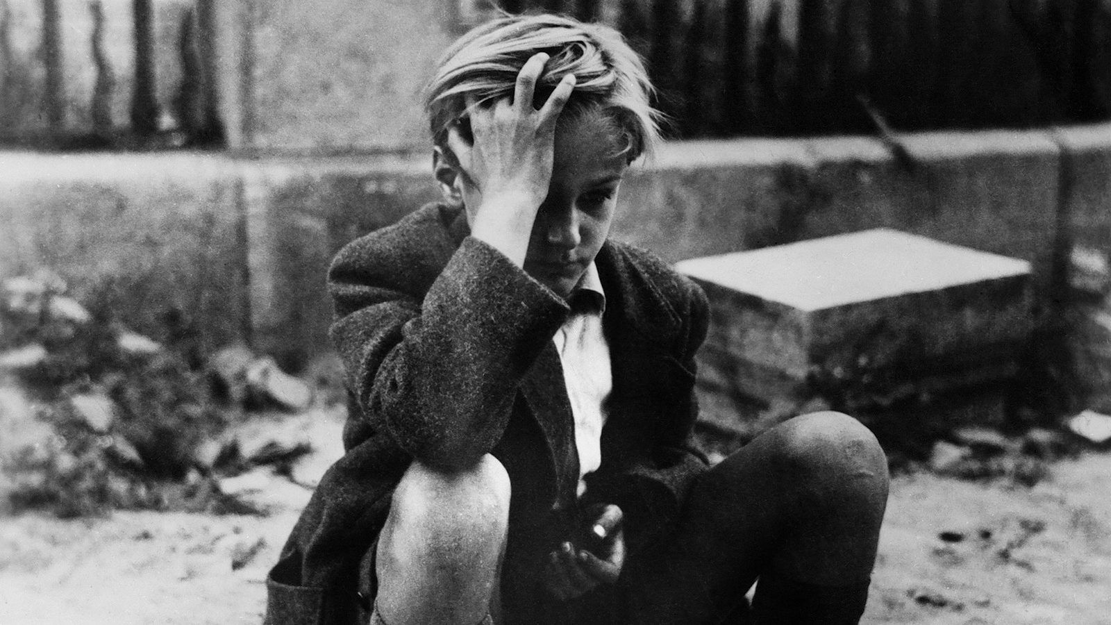Still from Rossellini film Germany Year Zero with the main character still in rubble, realizing that he's killed his father