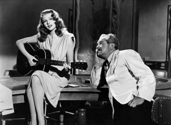 Scene from 1946 film Gilda in which title character plays guitar and sings