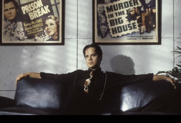 Still from The Player with Tim Robbins' character in his office, thinking