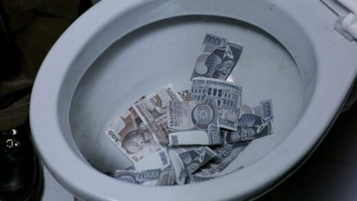 Still from the 1989 Michael Haneke film The Seventh Continent in which Geld is being flushed down the toilet